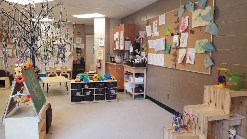 side of classroom with toy shelves and artwork displayed
